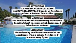 a sign next to a swimming pool at a resort at La Casa Di Mimi in Bardolino
