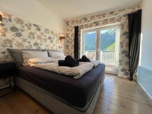 a large bed in a room with a window at Senja Aurora Lodge in Senja