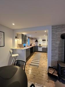 a kitchen with a table and a counter top at Senja Aurora Lodge in Senja
