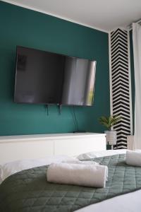 a bedroom with a large flat screen tv on the wall at Titanium in Izola