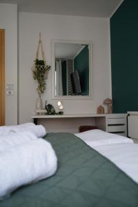 a bedroom with two beds and a mirror at Titanium in Izola