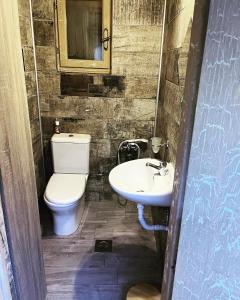 a bathroom with a toilet and a sink at The Countryside Loft in Katsikás +33 photos
