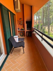 a balcony of a house with a chair at Aroeira Elite Apartments in Aroeira