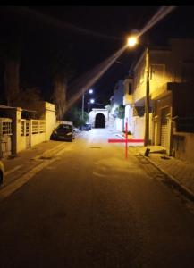 a car is parked on a street at night at l'Olivier in La Goulette
