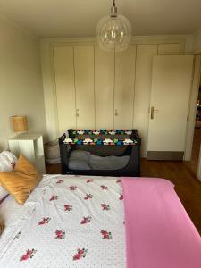 a bedroom with a bed with flowers on it at Aroeira Elite Apartments in Aroeira