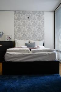 a bedroom with a large bed with a blue rug at Titanium in Izola