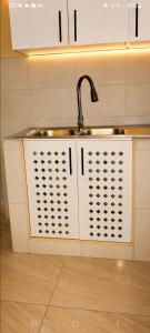 a kitchen sink with a faucet on top of it at UV Apartment in Lilongwe