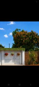 a white building with flowers on top of it at UV Apartment in Lilongwe