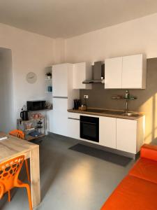a kitchen with white cabinets and a table in a room at Nice Sea Suite in Salerno