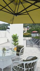 a patio with a table and chairs and an umbrella at PARALLEL Apartments in Gonio