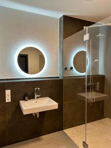 a bathroom with a sink and a shower at Hedwig und Paul in Mehring +92 photos