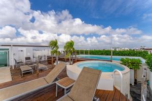 a balcony with a swimming pool on a roof at Downtown Playa close 5th Av Rooftop Pool in Playa del Carmen +14 photos