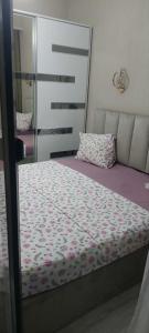 a bedroom with a bed and a mirror at Apartament Tbilisi in Tbilisi City