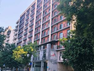 a tall building with a sign on the side of it at Apartament Tbilisi in Tbilisi City