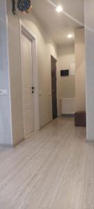 an empty room with a door and a hard wood floor at Apartament Tbilisi in Tbilisi City