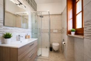 a bathroom with a shower and a sink and a toilet at Monte Cuccu Bed & Breakfast in Cerfignano