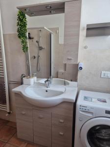 a bathroom with a sink and a washing machine at Castello Vignola in Vignola +24 photos