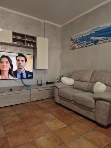 a living room with a couch and a flat screen tv at Castello Vignola in Vignola