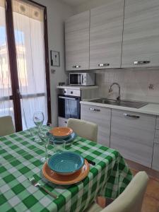 a kitchen with a table with a green and white checkered table cloth at Castello Vignola in Vignola