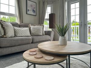 a living room with a couch and a table at Sunset Lodge in Warkworth