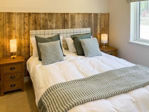 a bedroom with a large white bed with pillows at Lodge 3 - Uk51092 in Perranporth