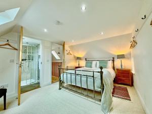a bedroom with a bed and a walk in shower at The Fish House in Rispond