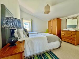 a bedroom with a bed and a dresser and a mirror at The Fish House in Rispond