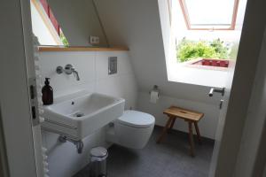 a bathroom with a sink and a toilet and a window at Lerchenhof in Balingen +13 photos