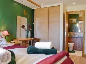 a bedroom with a bed and a bathroom at Reed Lodge in Littleport