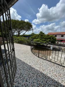 a gate on a walkway next to a building at Ruum1 Sugars Houz in Johor Bahru