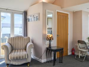 a living room with a chair and a table at Number 150 in Bessingby
