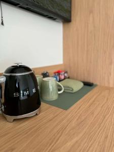 a toaster sitting on top of a wooden table at Tourist Hotel Queanbeyan in Queanbeyan