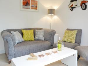 a living room with a couch and a coffee table at Happys in St Ives