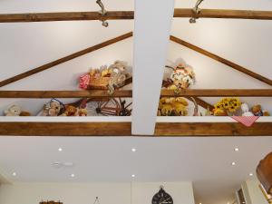 a bunch of stuffed animals on a shelf in a room at Sedge Lodge in Littleport