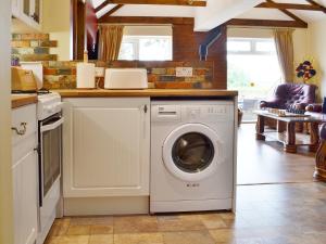 a kitchen with a washing machine in a kitchen at Sedge Lodge in Littleport +15 photos