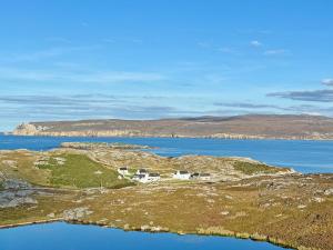 an island in the middle of a body of water at The Byre in Rispond +12 photos