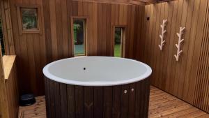 a bathtub in a room with wooden walls at Välgi Puhkepesa in Välgi