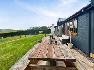 a wooden table in the backyard of a house at Poundgate Lodge in Knighton