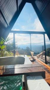 a bath tub in a room with a view of the water at Cabanas Terra Nova in Três Coroas