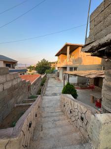 a stone retaining wall next to a building at Welcoming Multi-Bedroom House in Duhok