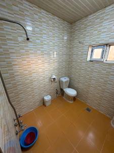 a small bathroom with a toilet and a sink at Welcoming Multi-Bedroom House in Duhok +5 photos