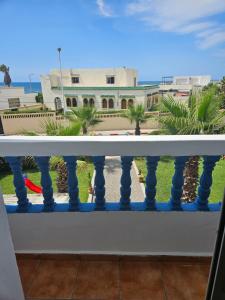 a balcony with a view of a building at Residence Zomroda Sidi Bouzid in Sidi Bouzid