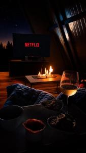 a glass of wine sitting on a bed with a fireplace at Cabanas Terra Nova in Três Coroas +14 photos