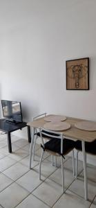 a dining room with a table and a chair at Studio moderne Évian, lac et therme in Évian-les-Bains