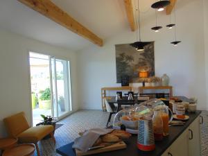 a kitchen with a table with food on it at Maison d'Hotes Les Palmiers in Gluiras