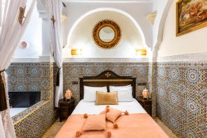 a bedroom with a bed with a teddy bear on it at Riad Olivier Marrakech medina in Marrakesh +111 photos