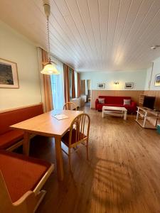 a living room with a table and a couch at Apparthotel Bliem in Schladming