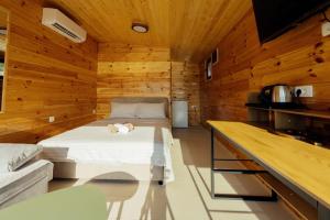 a bedroom with a bed in a wooden wall at Lenka & Anika in Nikšić