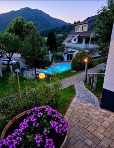 a garden with purple flowers and a swimming pool at Tiny House Eulenbach - Urlaub im Gletscherkessel Präg in Todtnau +55 photos