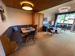 a living room with a couch and a table and chairs at Hotel Alpengasthof Löwen in Bad Hindelang